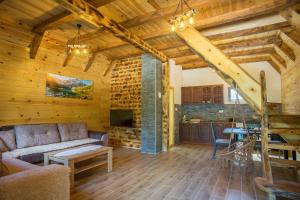 a living room with a couch and a table at Ville Uskoci in Žabljak
