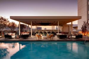 a hotel pool with chairs and a bar at Grand Bohemian Orlando, Autograph Collection in Orlando