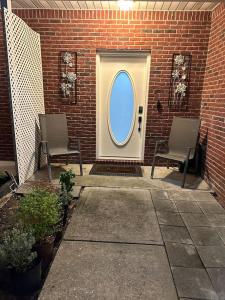 two chairs in front of a door with a window at Heart of Destin 3 Bed 2.5 bath. W/2 parking space in Destin