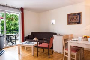 a living room with a couch and a table at Adonis Divonne-Les-Bains Résidence Du Lac in Divonne-les-Bains
