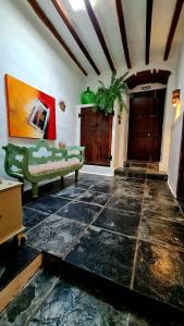 a living room with a green couch and a door at Luana House in Teguise