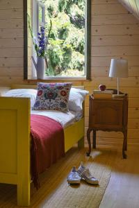 a bedroom with a bed and a window with shoes on the floor at Bratkowa Chata in Binczarowa