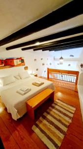 a bedroom with a large bed and a wooden floor at Luana House in Teguise