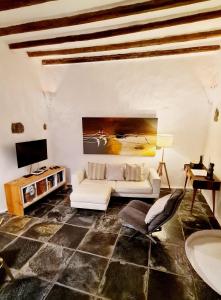 a living room with a white couch and a tv at Luana House in Teguise