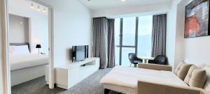 a hotel room with a bed and a tv at Grand Bay View Hotel in Hong Kong