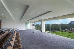 泗水的住宿－泗水吉莫薩瑞克利奧酒店，空的会议室,有椅子和讲台