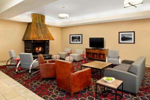 a living room with couches and a fireplace at Four Points by Sheraton Edmonton South in Edmonton