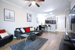 a living room with a couch and a table at Radiant 1BR Apartment Near Dallas Galleria in Farmers Branch