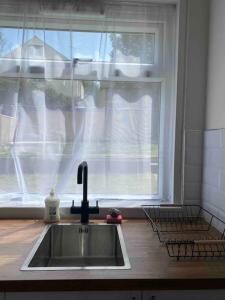 a kitchen sink in front of a window at Spacious Contemporary Home in Leeds