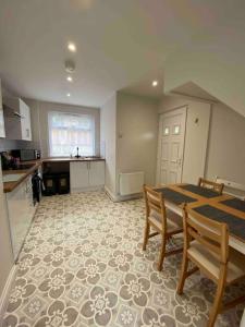 a kitchen and dining room with a table and chairs at Spacious Contemporary Home in Leeds