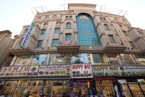 a large building with signs in front of it at Cube Hotel Dubai formerly Al Buraq Hotel Al Ras in Dubai