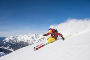 a man is skiing down a snow covered mountain at Haus Barbara in Wald am Arlberg