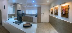 a kitchen with a white counter top in a room at Fiddlewood Beach House in Port Shepstone