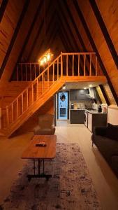 a living room with a wooden staircase in a attic at Ay-Ra Bungalow Suite in Kas