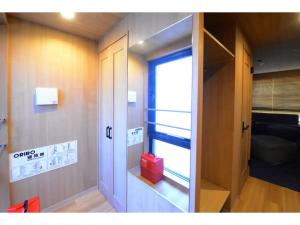 a room with a door and a room with a window at THE BONDS HOTEL TOKYO - Vacation STAY 48446v in Tokyo
