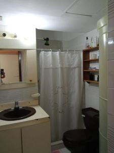 a bathroom with a shower curtain and a sink at Esparta Suite isla de margarita in Porlamar