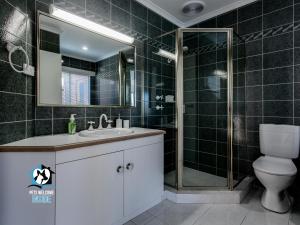 a bathroom with a toilet and a sink and a shower at Beautiful Lake Views with Pontoon in Encounter Bay +12 photos