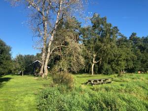 a park with two picnic tables in the grass at IJsselgoud in Zwolle