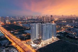 an aerial view of a large city at night at Aspaces Serviced Apartments - Vinhomes West Point in Hanoi