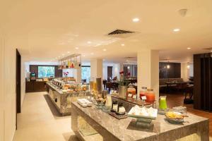 a restaurant with a buffet line in a building at Southern Star,Mysore in Mysore