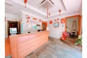 a restaurant with a counter in a room at OYO 90847 Hotel Asia City in Kota Kinabalu