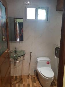 a bathroom with a toilet and a glass sink at Rabbit House แรบบิท เฮ้าส์ in Ban Han Tra Fang Nua