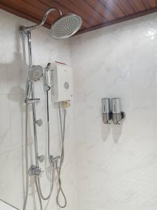 a shower with a shower head in a bathroom at Rabbit House แรบบิท เฮ้าส์ in Ban Han Tra Fang Nua