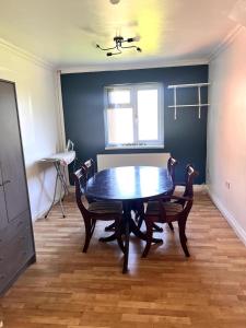 a dining room with a table and chairs and a window at Ensuite Room Platinum 1 Harborne - Quinton Road in Birmingham