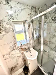a white bathroom with a sink and a shower at Ensuite Room Platinum 1 Harborne - Quinton Road in Birmingham