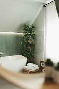 a bathroom with a sink and a potted plant at Casa Cerbului in Baia-Sprie