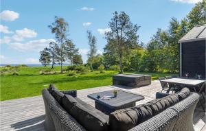 a patio with a couch and a table and a grill at Cozy Home In Hjslev With Wifi in Højslev