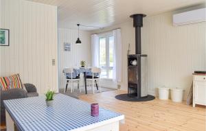 a living room with a stove and a table at Gorgeous Home In Dronningmlle With Wifi in Dronningmølle