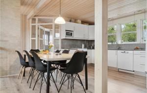 a kitchen and dining room with a table and chairs at Awesome Home In Glesborg With Wifi in Bønnerup