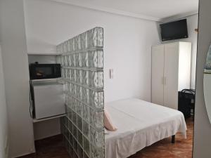 a room with a wall with a bed in it at Pensión Navarra in Madrid