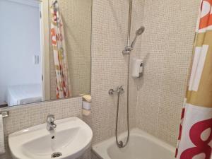 a bathroom with a sink and a shower at Pensión Navarra in Madrid