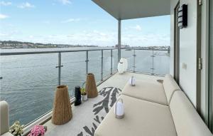a balcony with a view of the water at Amazing Apartment In Haugesund With Outdoor Swimming Pool, Wifi And 3 Bedrooms in Haugesund