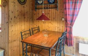 a dining room with a wooden table and chairs at Nice Home In Olden With 2 Bedrooms in Olden