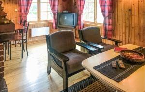 a living room with two chairs and a tv at Nice Home In Olden With 2 Bedrooms in Olden