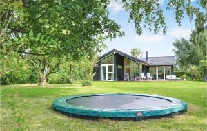 a house with a trampoline in the yard at Gorgeous Home In Dronningmlle With Wifi in Dronningmølle