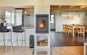 eine Küche und ein Wohnzimmer mit Kamin in der Unterkunft Lovely Home In Ulfborg With Kitchen in Sundhuse