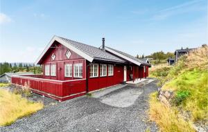 una casa roja al lado de una colina en Lovely Home In Svingvoll With Sauna en Svingvoll