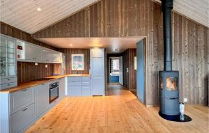 a large kitchen with a stove in the middle at Lovely Home In Svingvoll With Sauna in Svingvoll