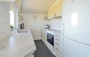 AllingåbroにあるStunning Home In Allingbro With 2 Bedroomsの白いキッチン(シンク、冷蔵庫付)