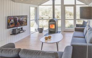 a living room with a wood stove in a room at Cozy Home In Harbore With House A Panoramic View in Harboør