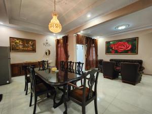 a dining table and chairs in a living room at De Hanami Homestay Setrayasa in Cirebon