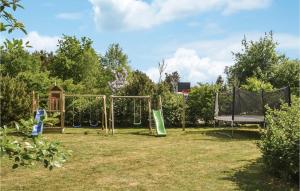 a park with a swing set and a playground at Holiday Home Bøgelunden Oksbøl Ii in Oksbøl +26 photos