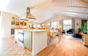a kitchen and dining room with a table and chairs at Gorgeous Home In Blvand With Kitchen in Blåvand