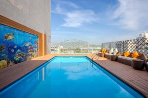 a swimming pool with a mural on the side of a building at Navy Hotel Nha Trang in Nha Trang