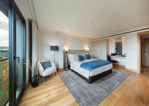 a hotel room with a bed and a desk at Tower Suites by Blue Orchid in London