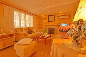 a living room with a couch and a fireplace at Ideal Property Mallorca - Villa Benestar in El Toro